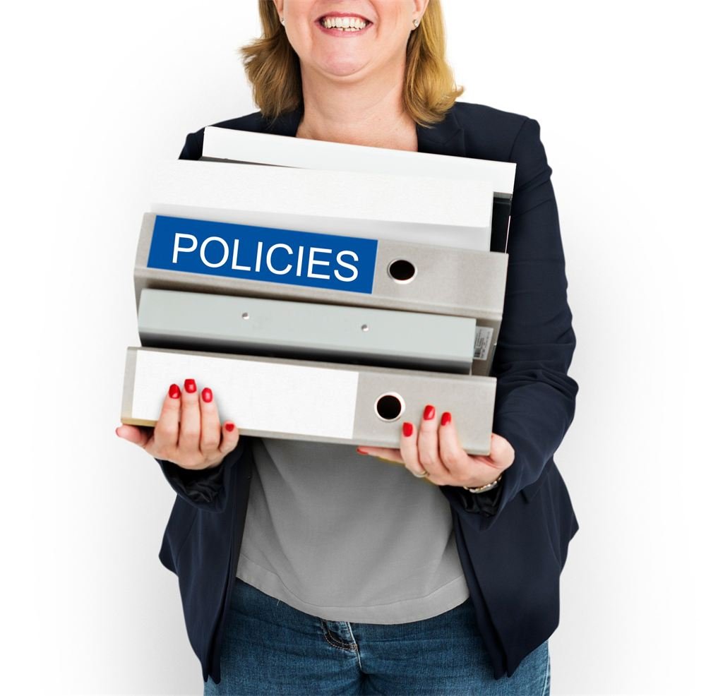 Stack of HR policies and procedures binders